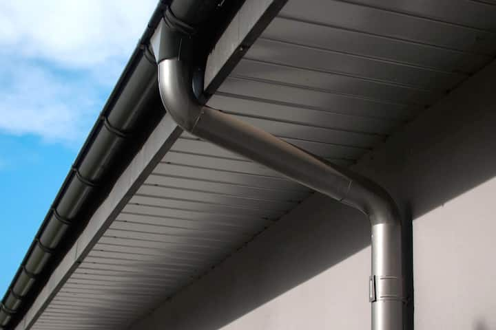 Corrosion-resistant galvanized gutters installed on a commercial building in Rochester